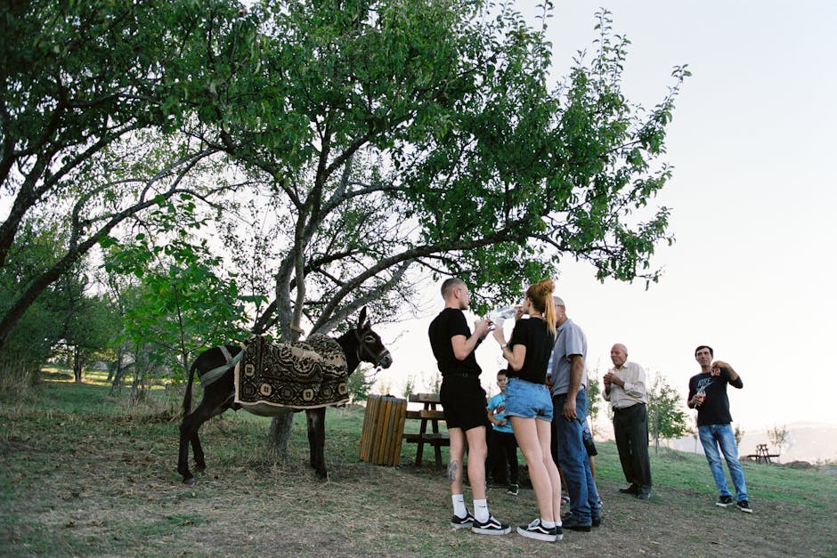 A family enjoys a picnic in a park with eco-friendly travel gear, surrounded by a beautiful landscape