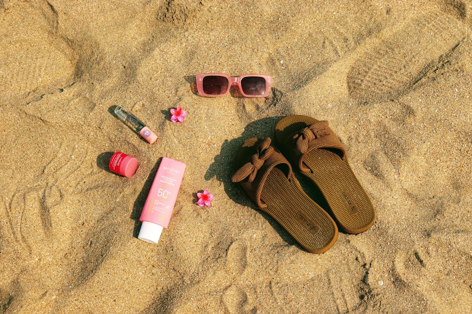 Traveler packing sunscreen and sunglasses as part of travel packing tips for different climates