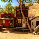 Abandoned ghost town in the American West featuring art galleries and quirky shops, perfect for unique travel experiences off the beaten path