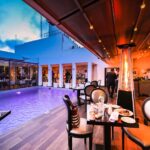 Luxurious hotel room featuring elegant Murano glass chandeliers and beautifully frescoed walls, ideal for luxury hotel reviews for European destinations