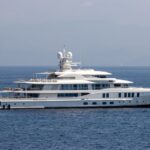 A luxurious private yacht cruising the Mediterranean, complete with champagne, showcasing luxury travel experiences to try in 2026