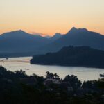 Serene landscape of Luang Prabang, Laos, showcasing the Mekong River and traditional architecture, a hidden gem travel destination in Asia