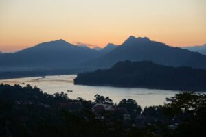 Serene landscape of Luang Prabang, Laos, showcasing the Mekong River and traditional architecture, a hidden gem travel destination in Asia
