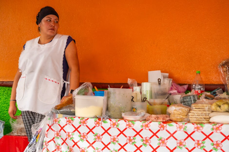 Vibrant street scene in Mexico City with colorful buildings and food vendors, showcasing a lively atmosphere