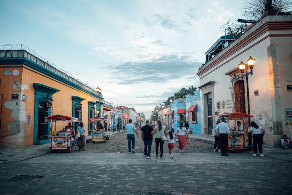 Colorful architecture in Oaxaca, Mexico, featuring vibrant buildings and street food vendors bustling in the scene
