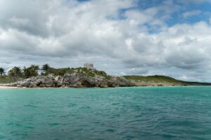 Tropical beach with turquoise waters and ancient ruins, showcasing one of the cheap countries to visit with beaches